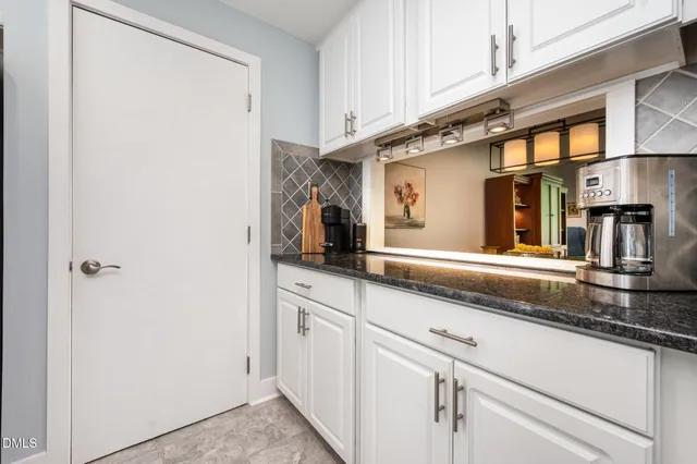 a kitchen with stainless steel appliances granite countertop a sink and a granite counter tops