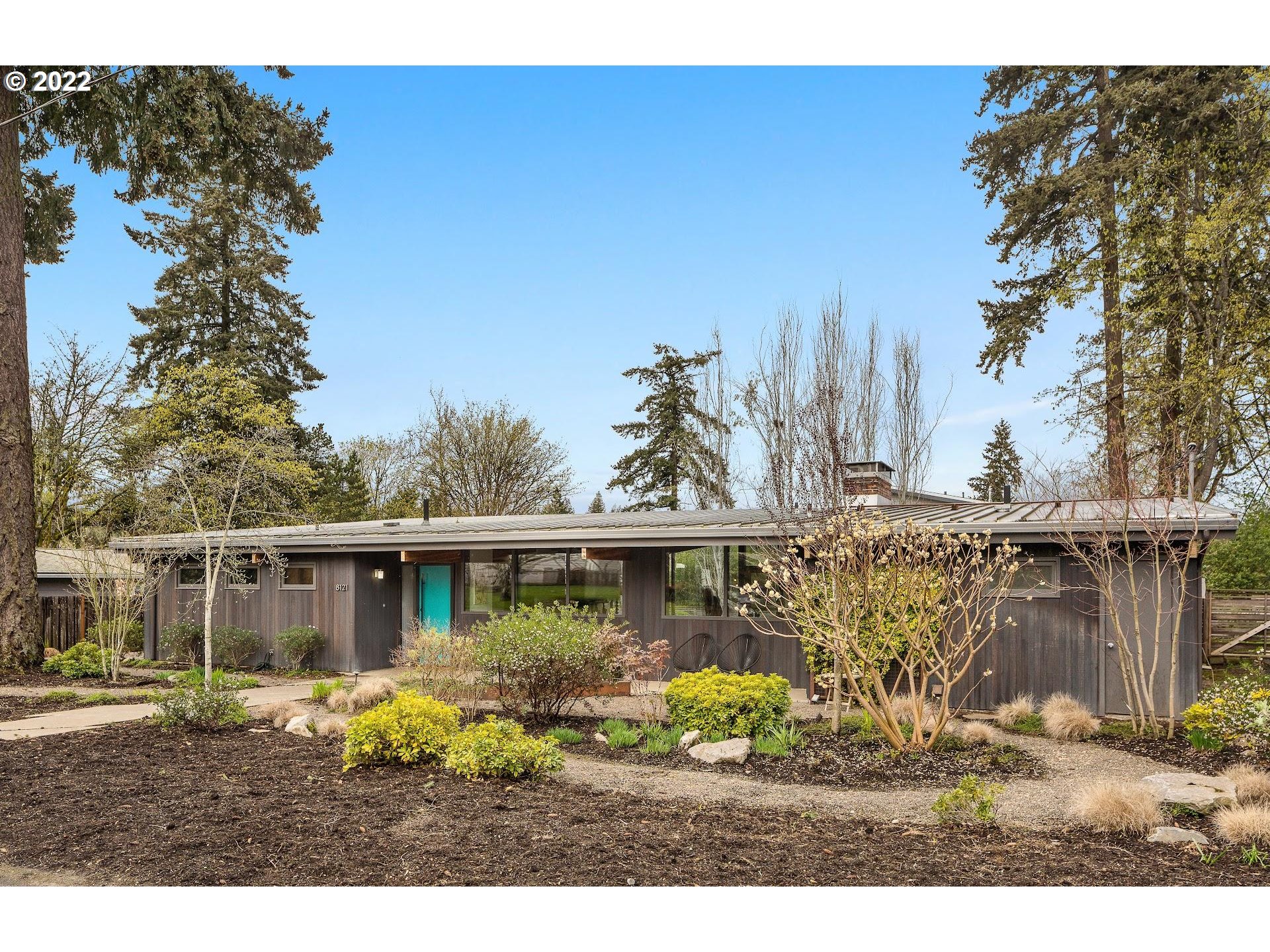a front view of a house with a garden