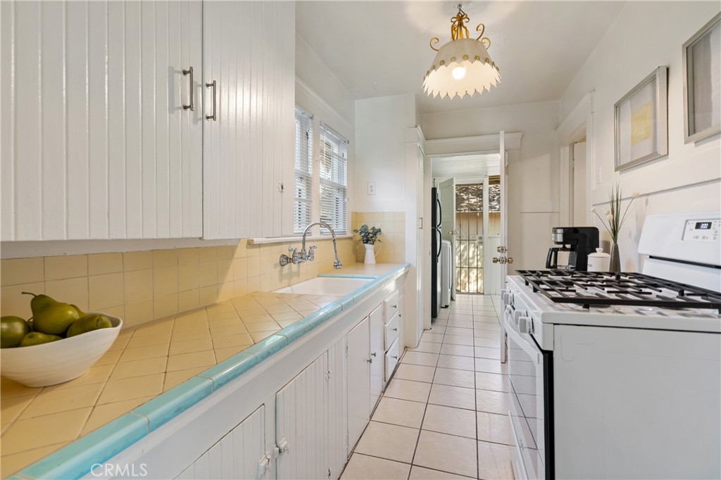 846 North Wilson Avenue Pasadena, CA 91104 - Photo 15 of 37 a kitchen with stainless steel appliances granite countertop a sink stove and cabinets