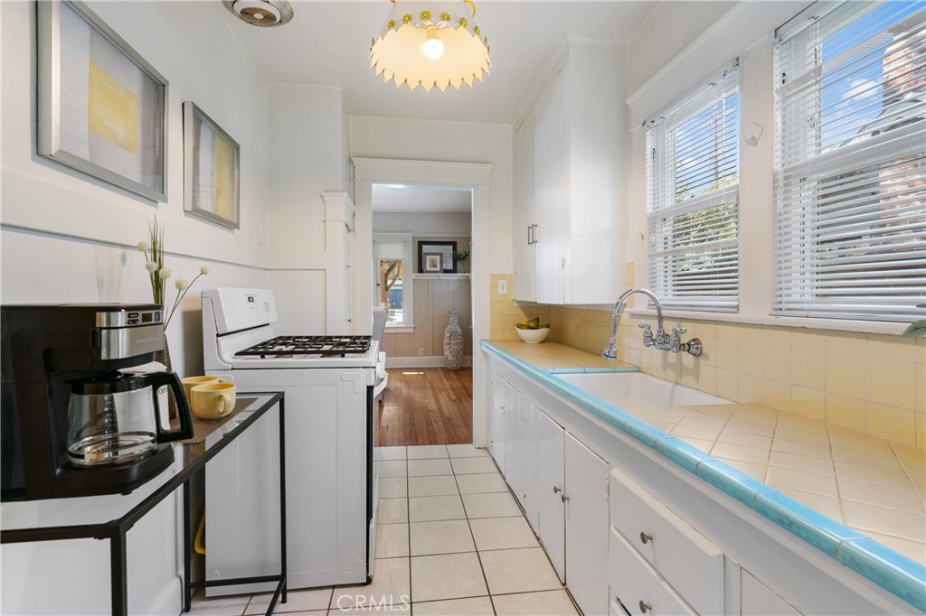 846 North Wilson Avenue Pasadena, CA 91104 - Photo 16 of 37 a kitchen with stainless steel appliances granite countertop a sink stove and refrigerator