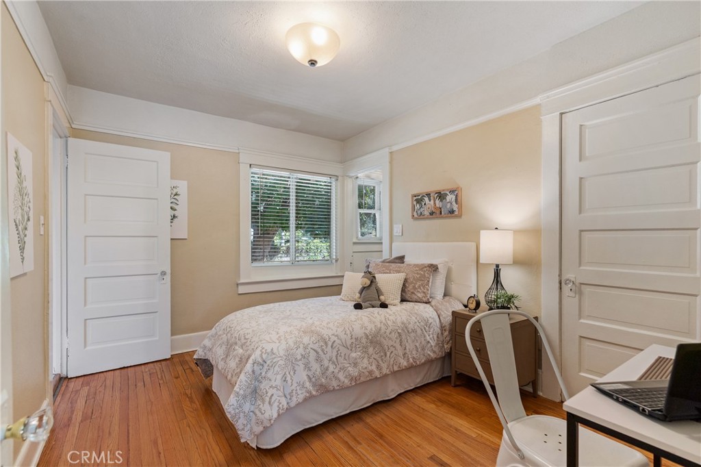 846 North Wilson Avenue Pasadena, CA 91104 - Photo 18 of 37 a bedroom with a bed a chair and next to a window