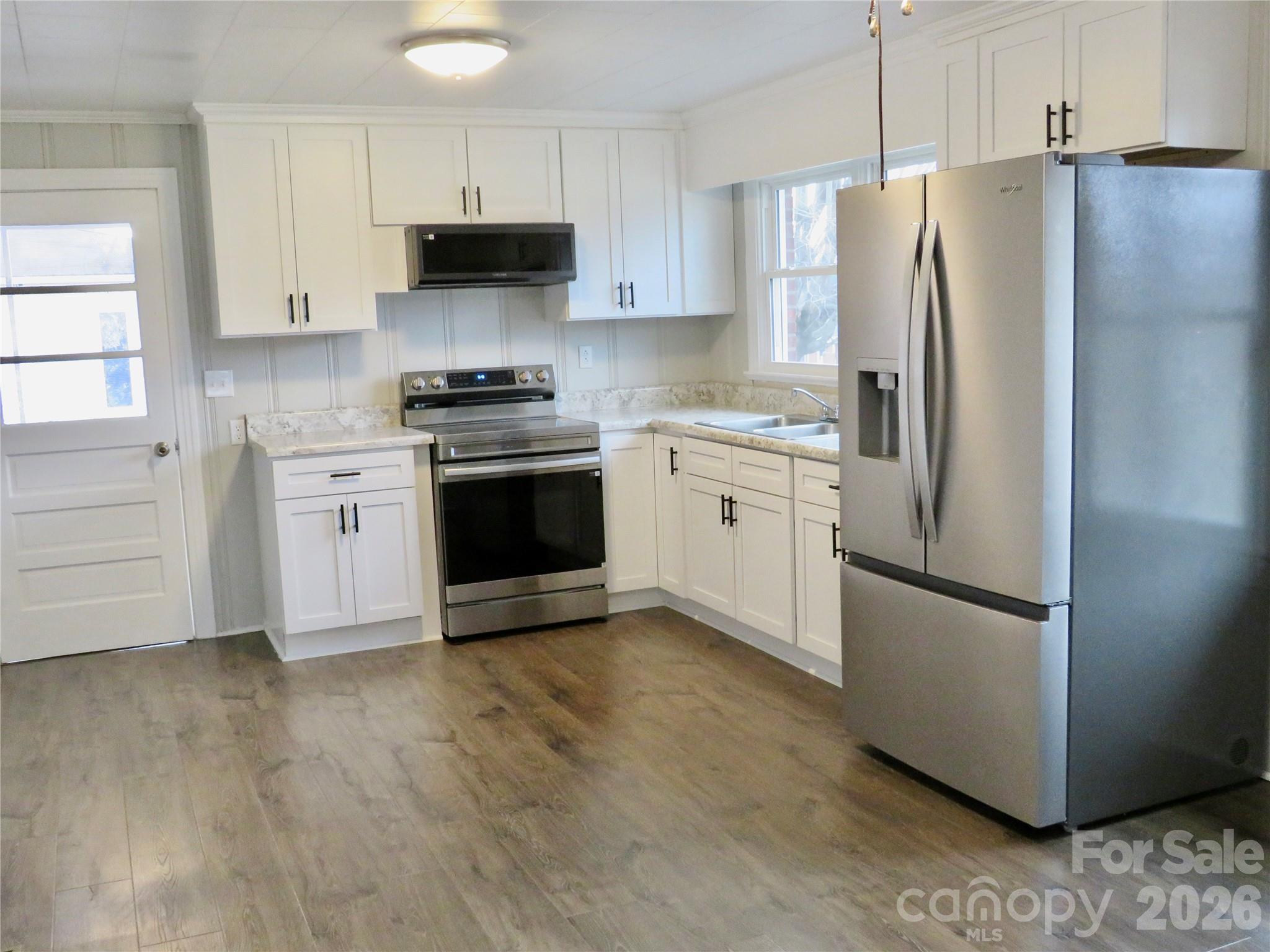 274 Georgia Street Spindale, NC 28160 - Photo 11 of 25 a kitchen with stainless steel appliances granite countertop a refrigerator stove and a sink
