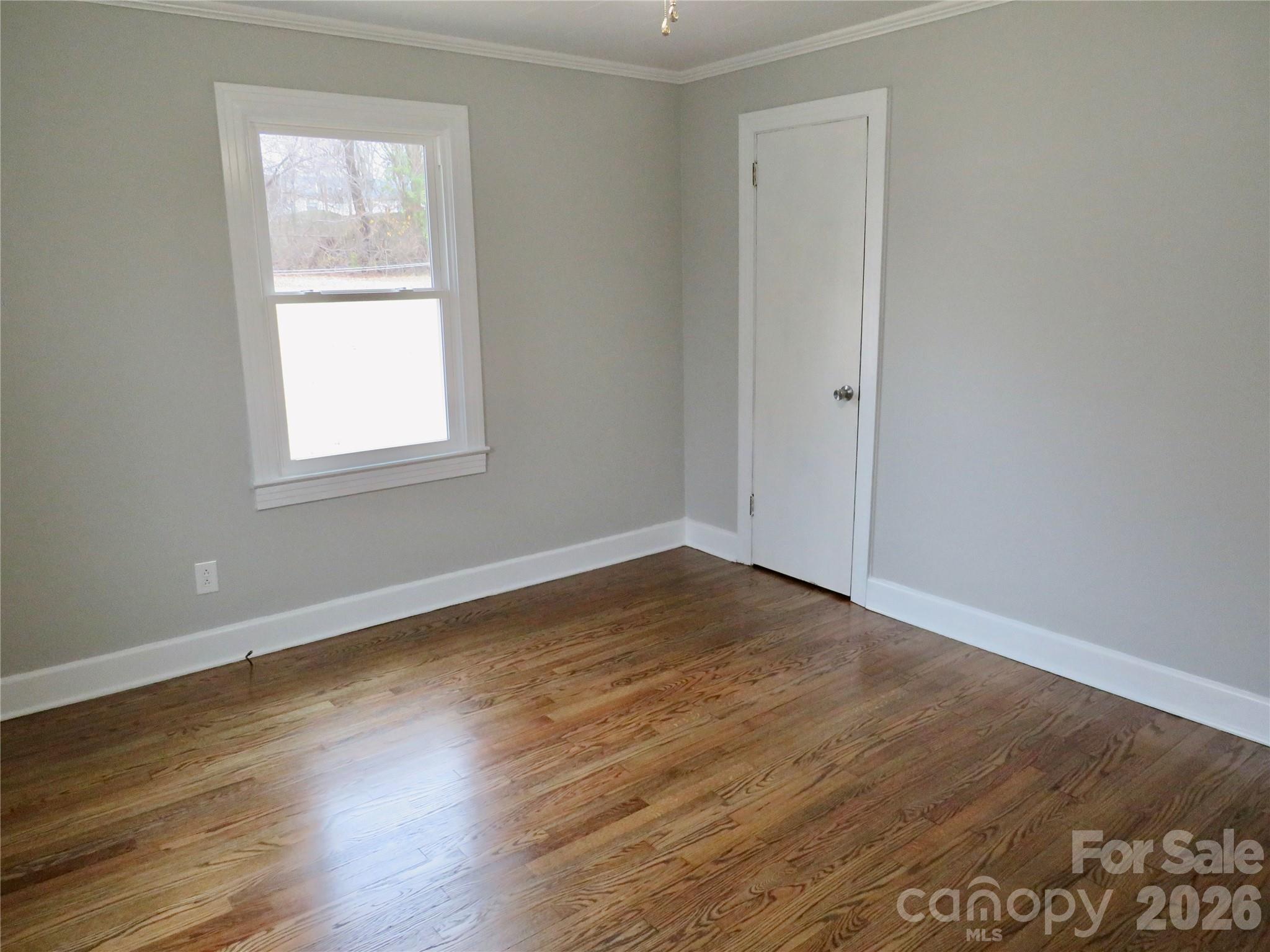 274 Georgia Street Spindale, NC 28160 - Photo 13 of 25 an empty room with wooden floor and windows