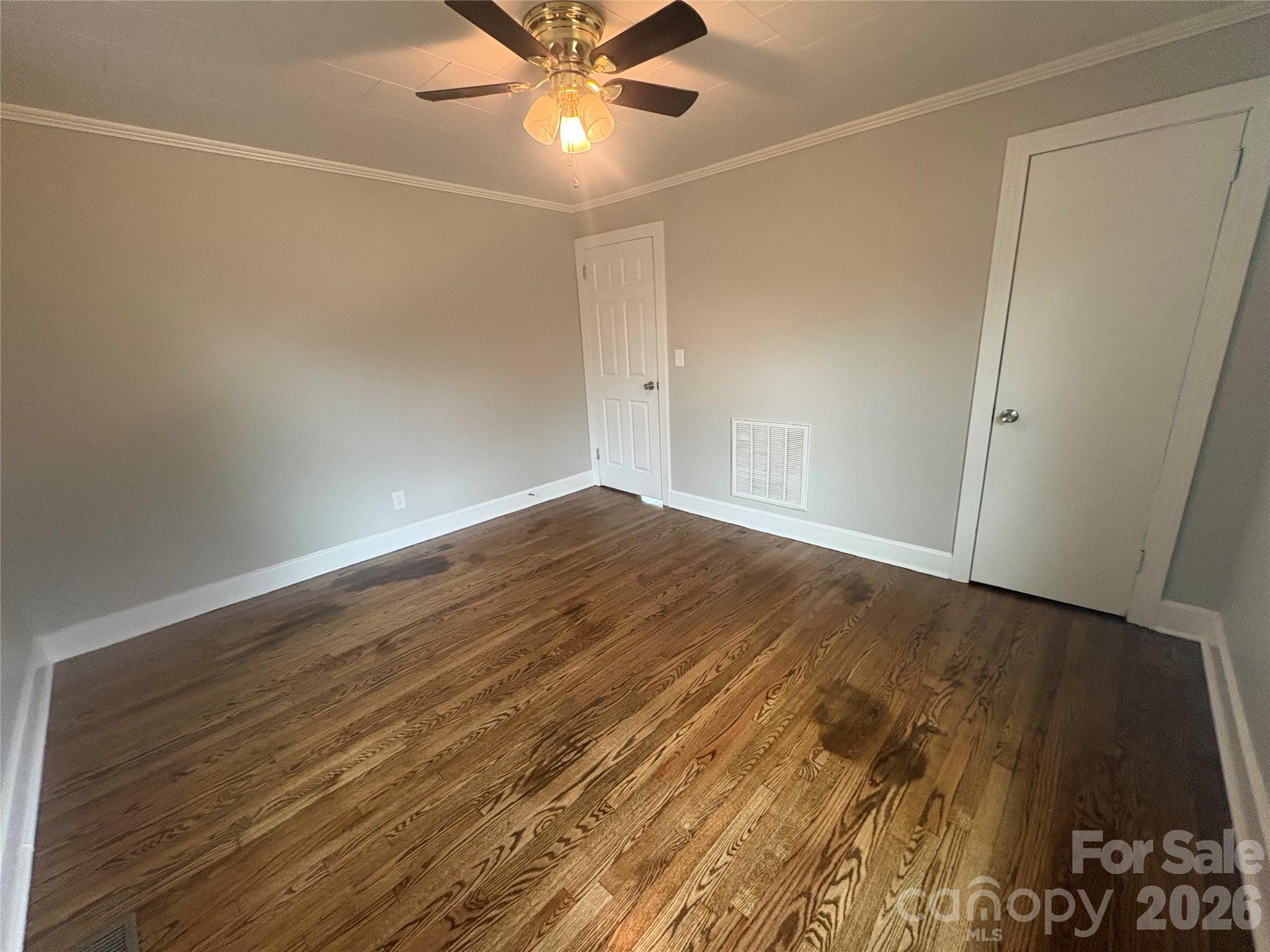274 Georgia Street Spindale, NC 28160 - Photo 18 of 25 an empty room with wooden floor and fan