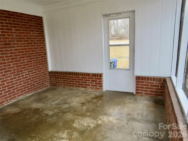 a view of a door and an empty room