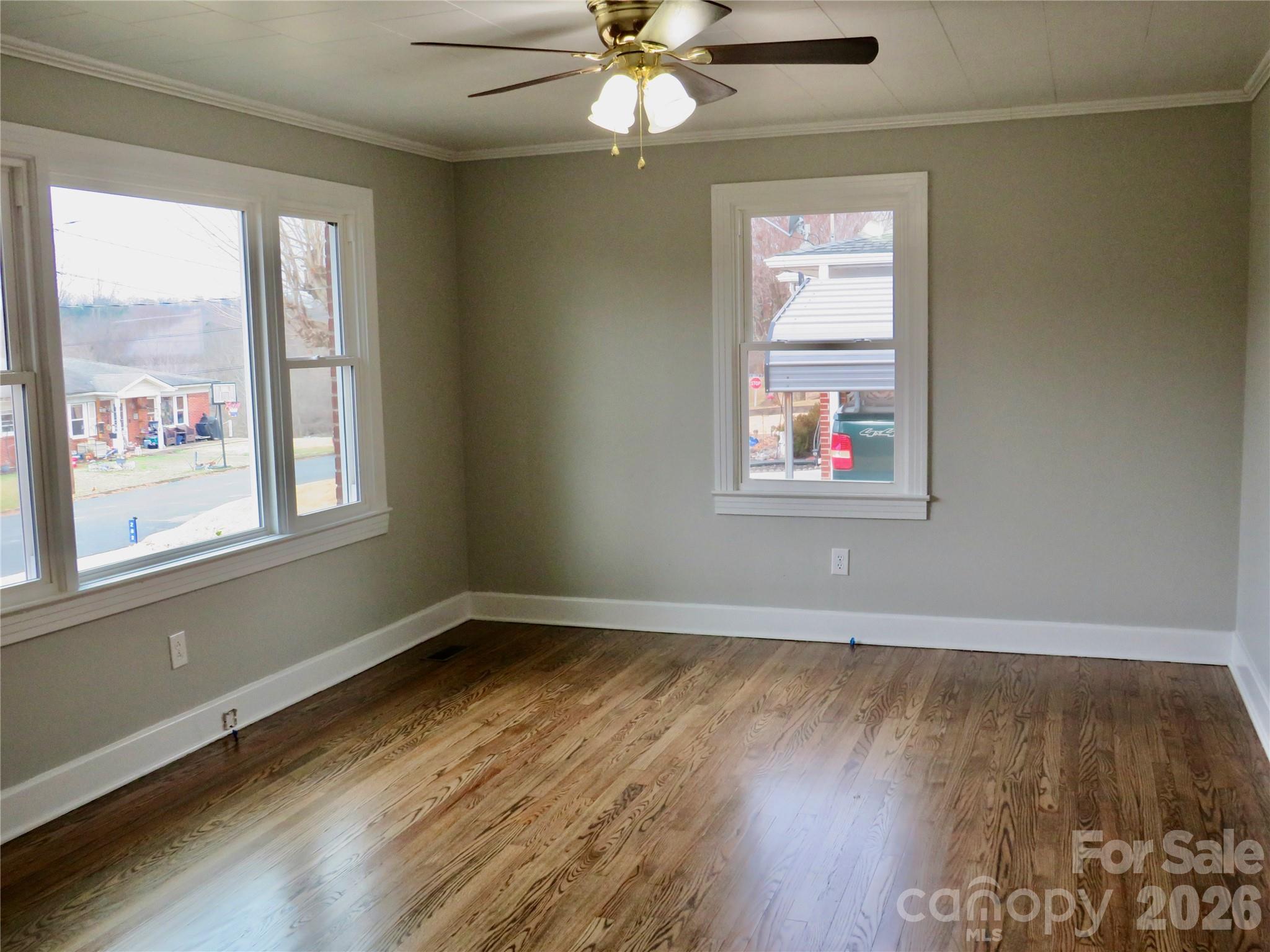 274 Georgia Street Spindale, NC 28160 - Photo 5 of 25 a view of an empty room with wooden floor and a window
