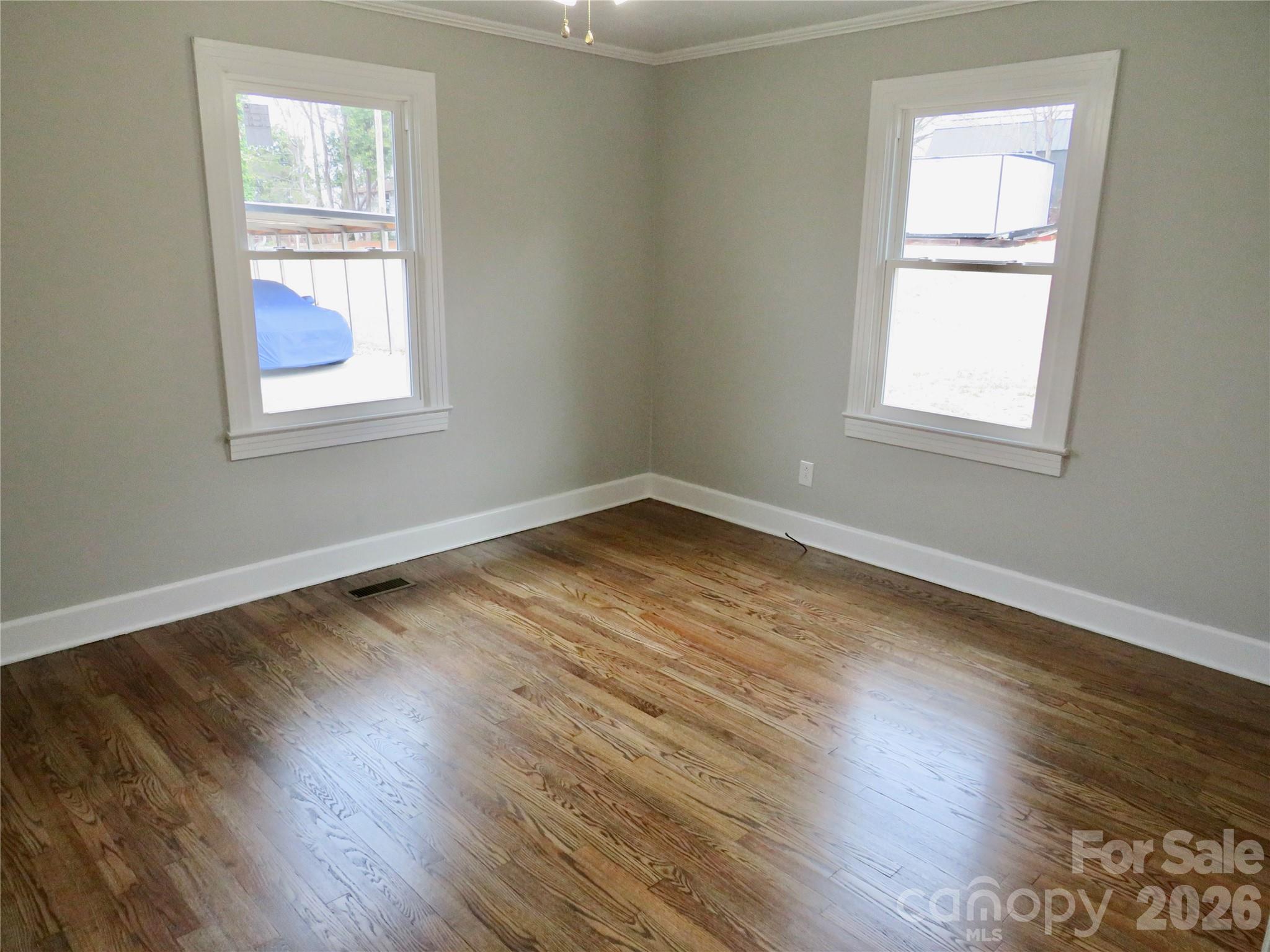 274 Georgia Street Spindale, NC 28160 - Photo 6 of 25 a view of an empty room with wooden floor and a window