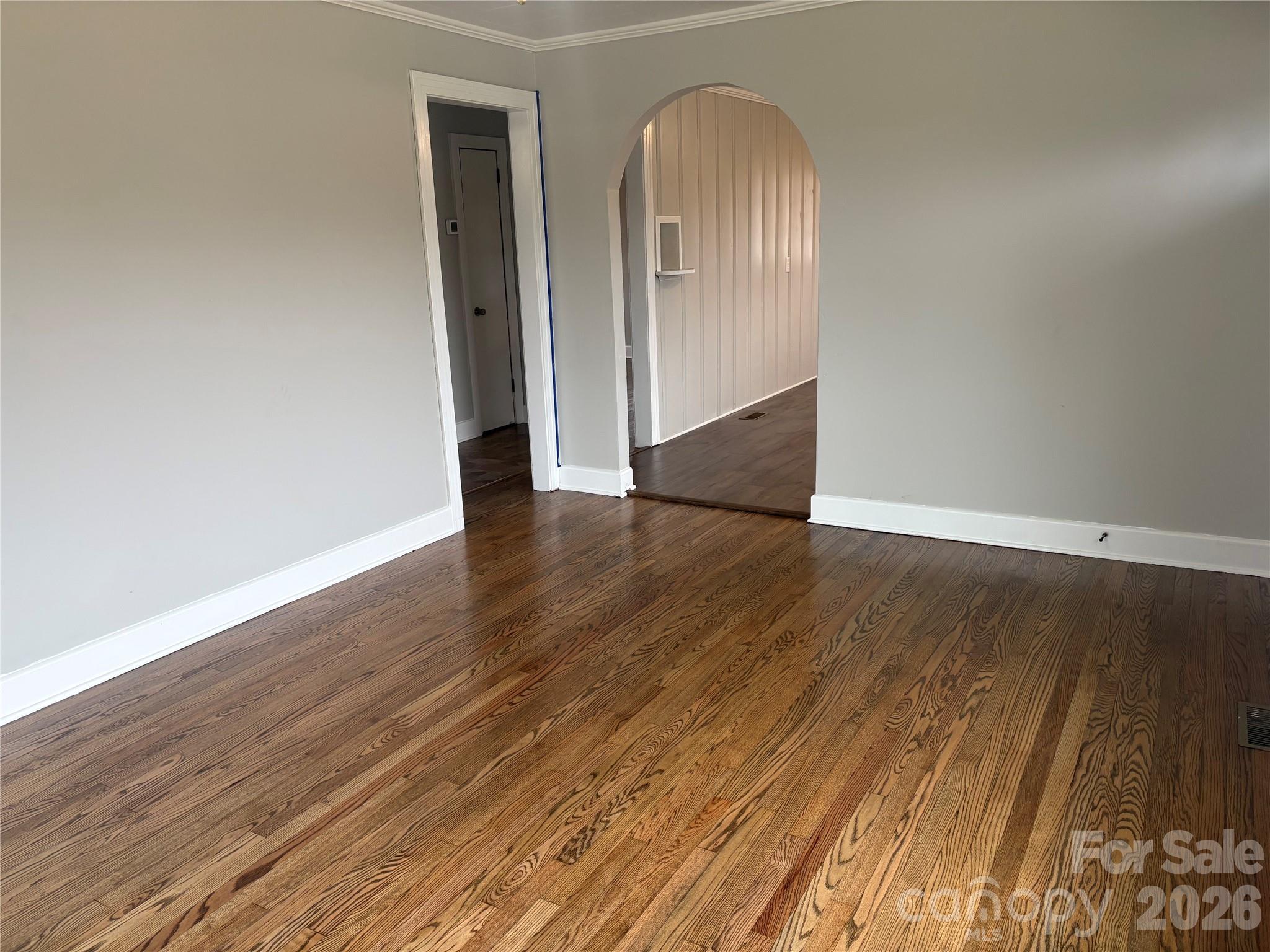 274 Georgia Street Spindale, NC 28160 - Photo 7 of 25 an empty room with wooden floor and mirror