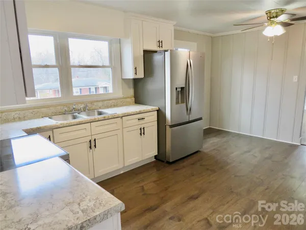 a kitchen with stainless steel appliances a refrigerator a sink a stove and cabinets