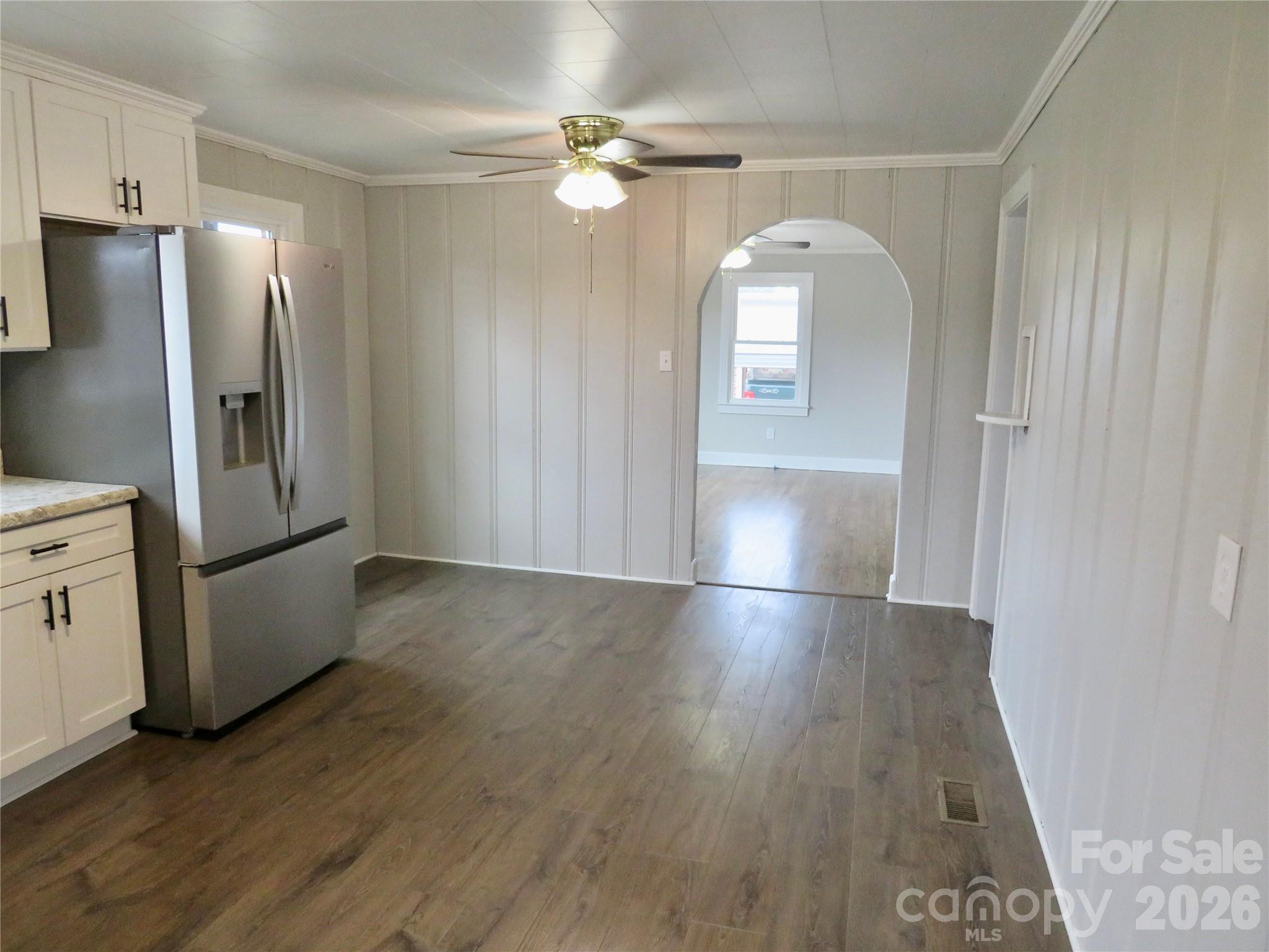 274 Georgia Street Spindale, NC 28160 - Photo 10 of 25 an empty room with wooden floor cabinet and windows