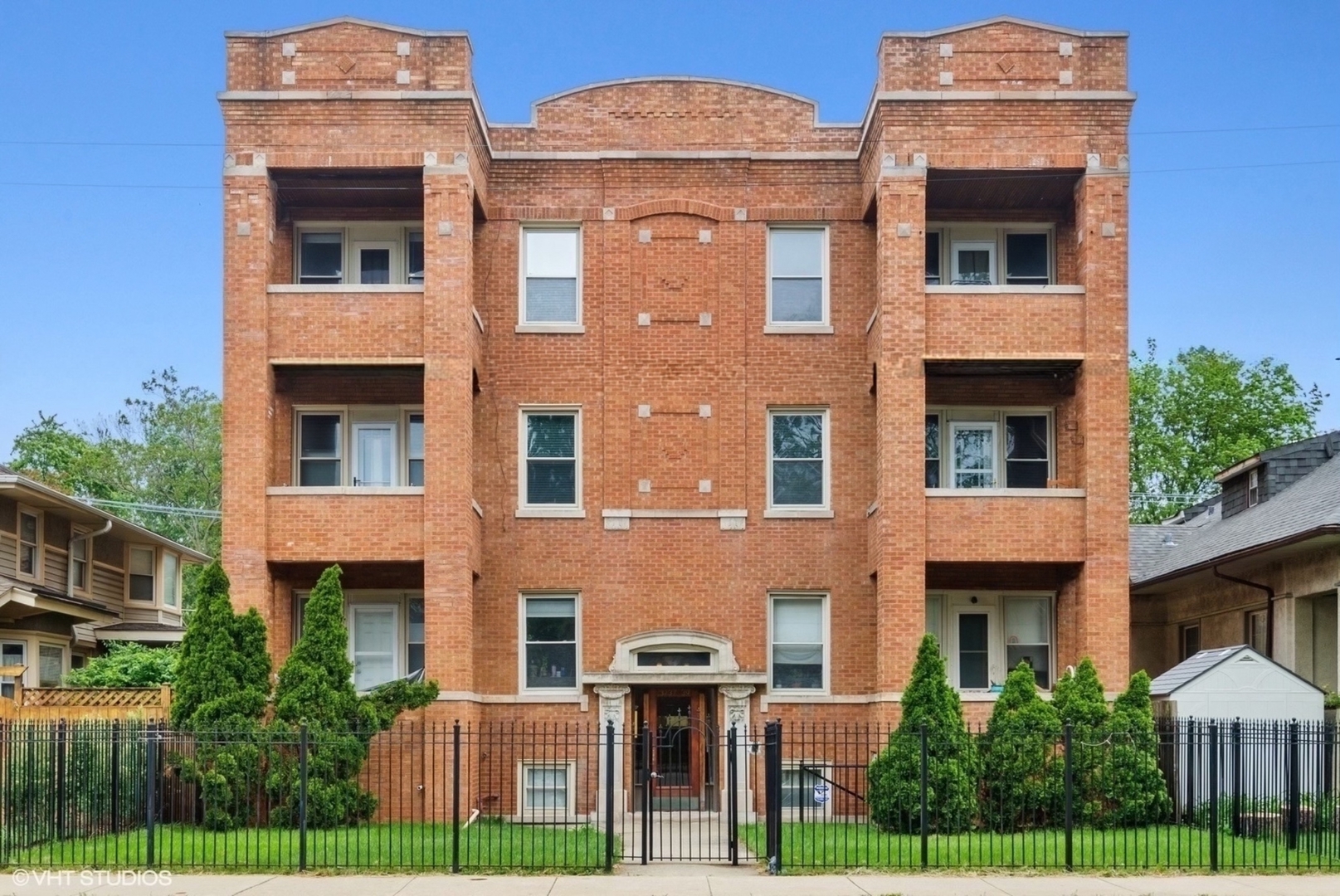a front view of residential houses with yard