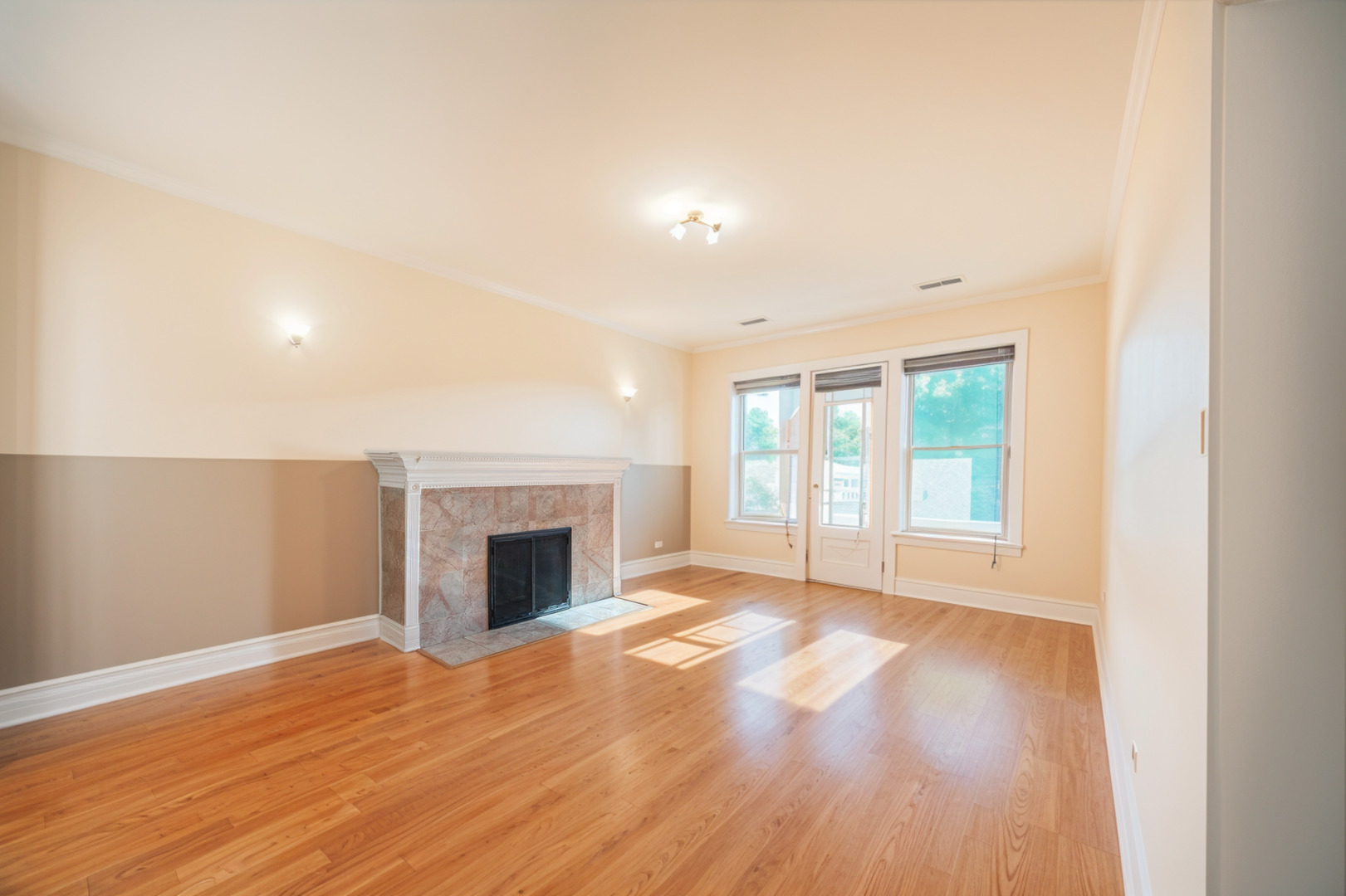 3737 North Pulaski Road, Unit 2S Chicago, IL 60641 - Photo 2 of 33 an empty room with wooden floor fireplace and windows