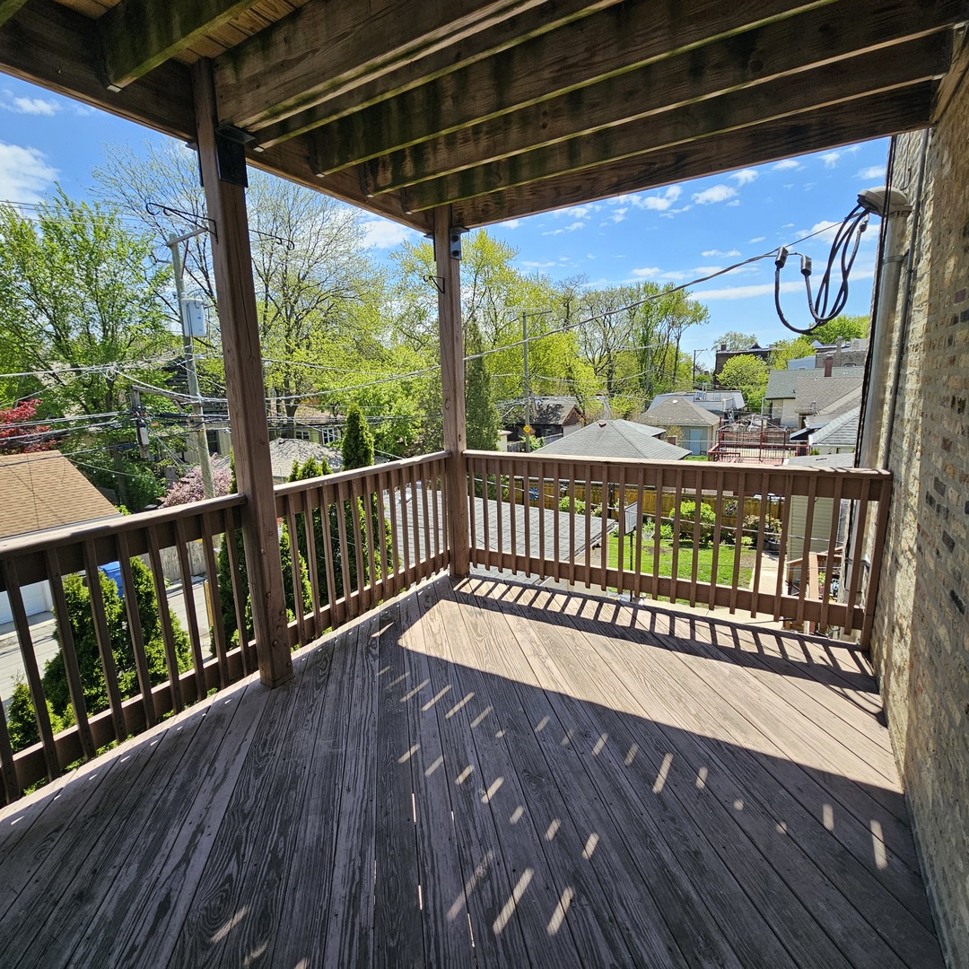 3737 North Pulaski Road, Unit 2S Chicago, IL 60641 - Photo 26 of 33 a view of a porch with wooden floor