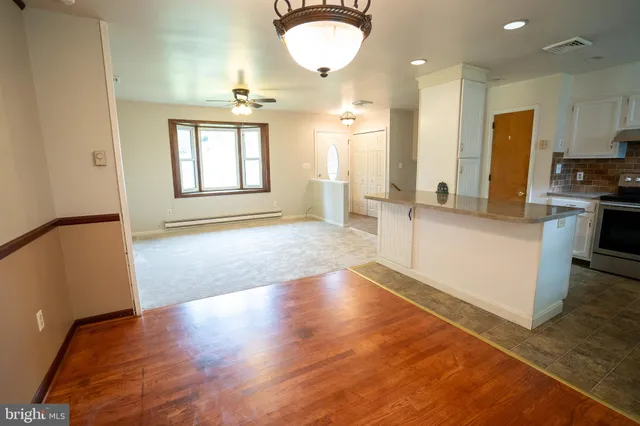 a view of a kitchen with a sink and a refrigerator
