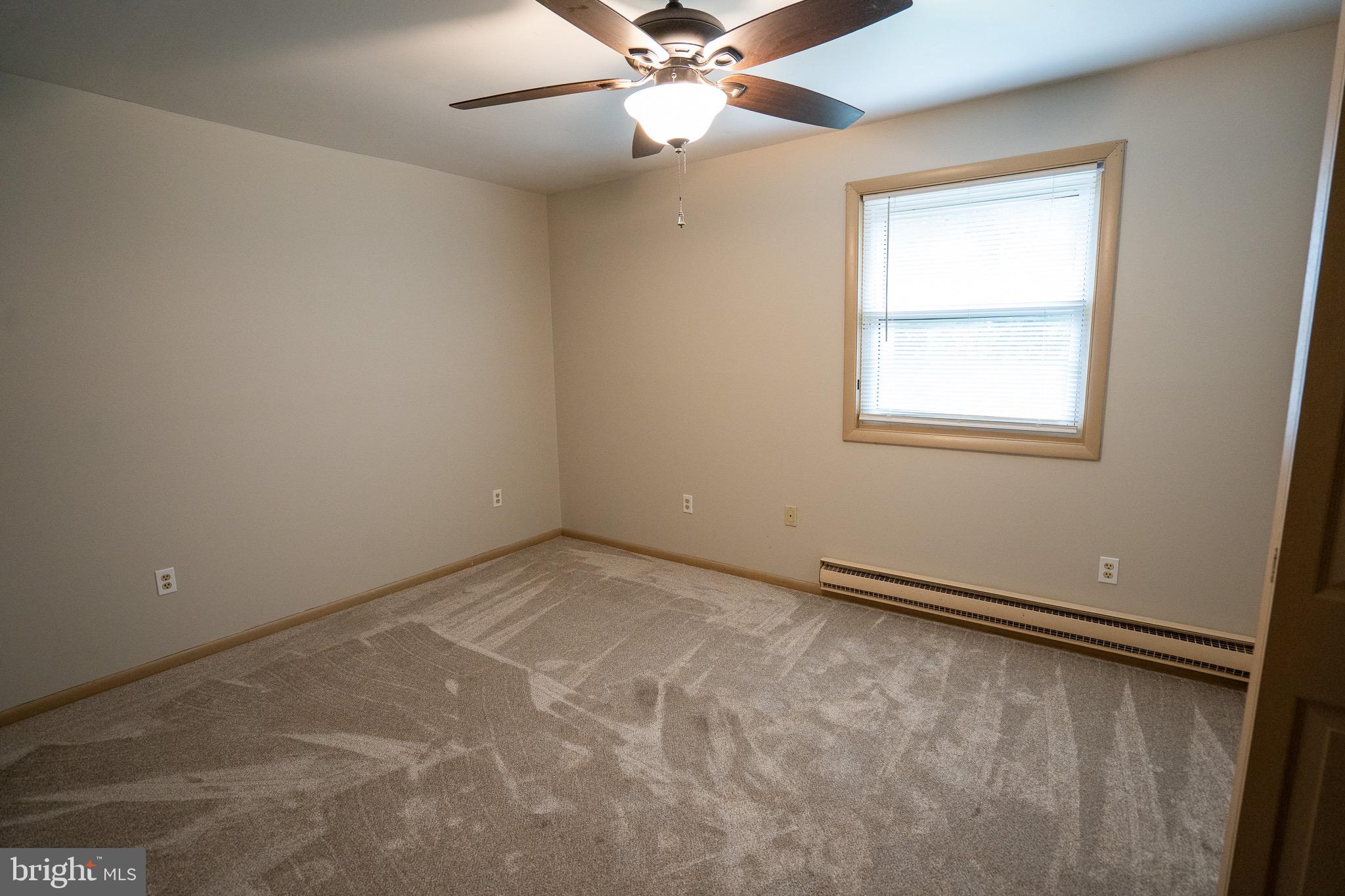 8 Sherri Lane Lititz, PA 17543 - Photo 19 of 43 an empty room with a window and a fan
