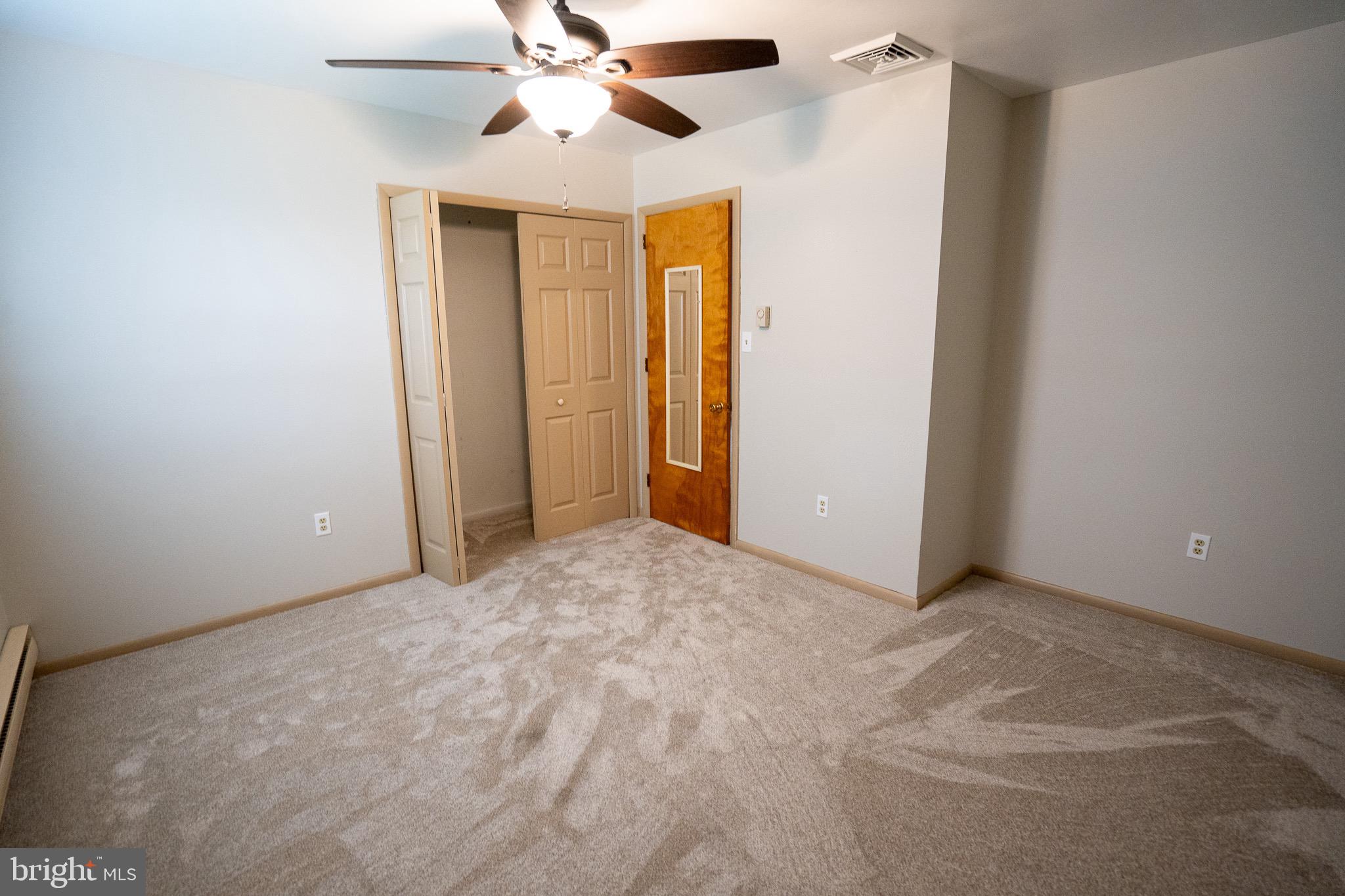 8 Sherri Lane Lititz, PA 17543 - Photo 20 of 43 an empty room with a ceiling fan and a window