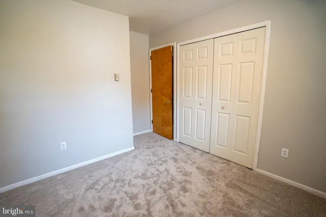 an empty room with closet area