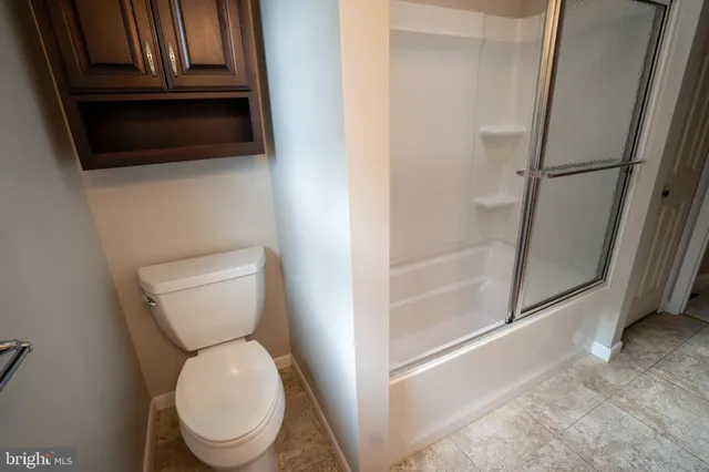 a white toilet sitting next to a bathroom sink
