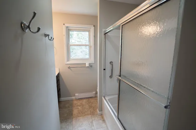a bathroom with a glass shower door