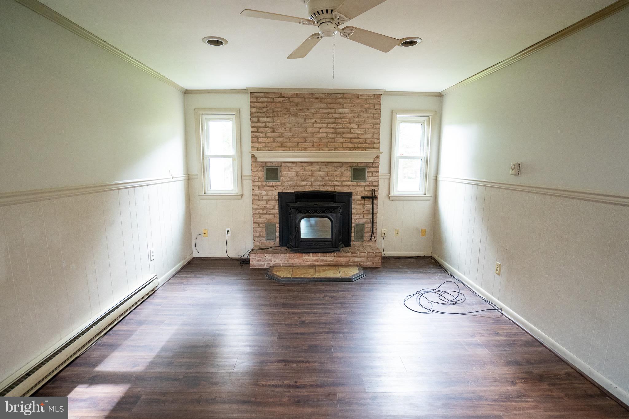 8 Sherri Lane Lititz, PA 17543 - Photo 27 of 43 an empty room with wooden floor fireplace and windows