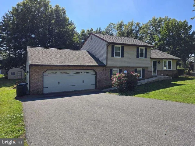 a view of a house with a yard and garage