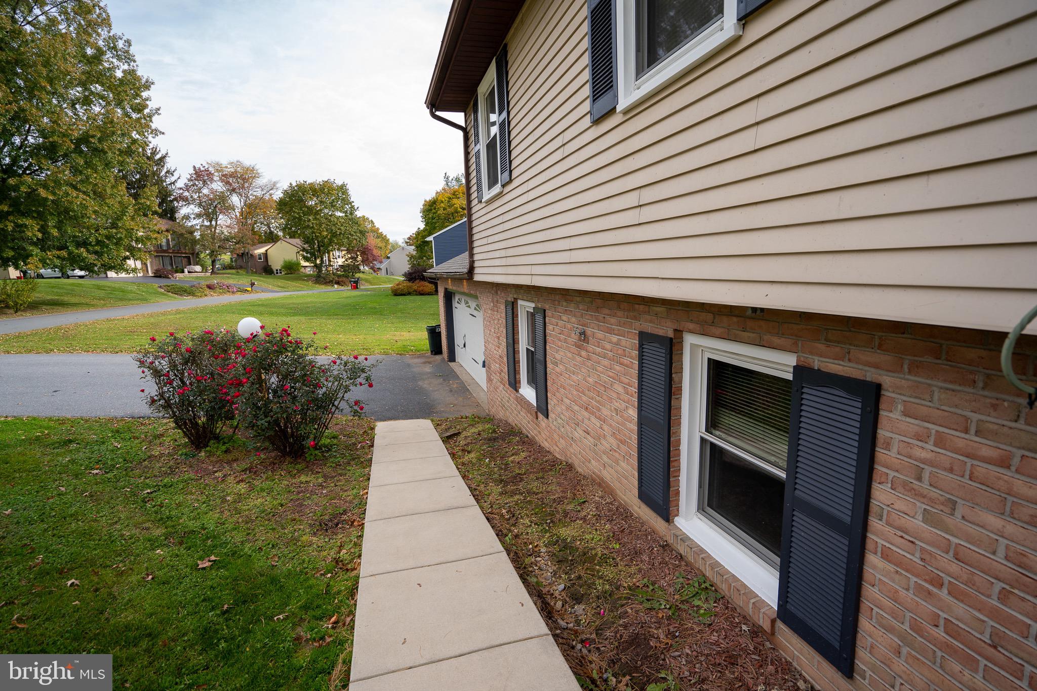 8 Sherri Lane Lititz, PA 17543 - Photo 5 of 43 a front view of a house with a garden
