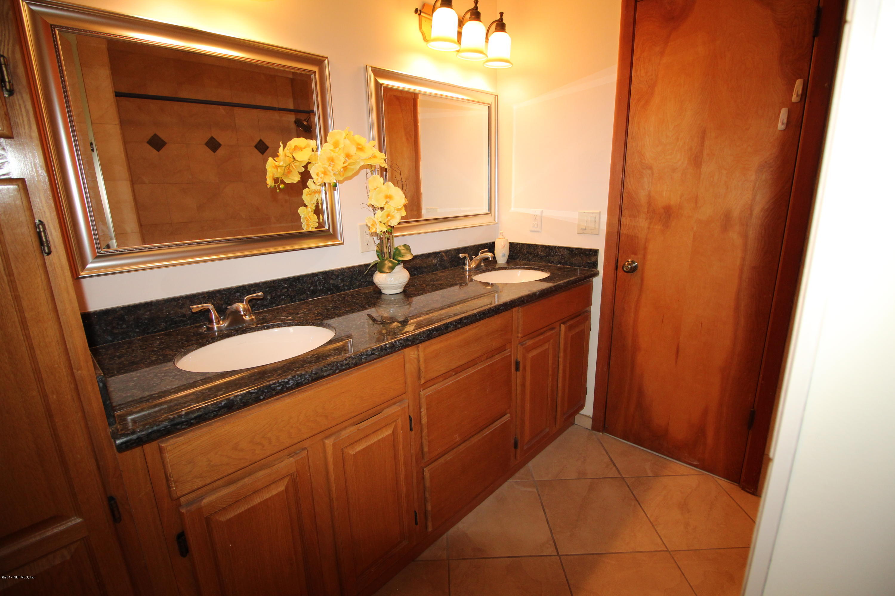 233 Swallow Road St. Augustine, FL 32086 - Photo 16 of 29 a bathroom with a granite countertop sink and a mirror