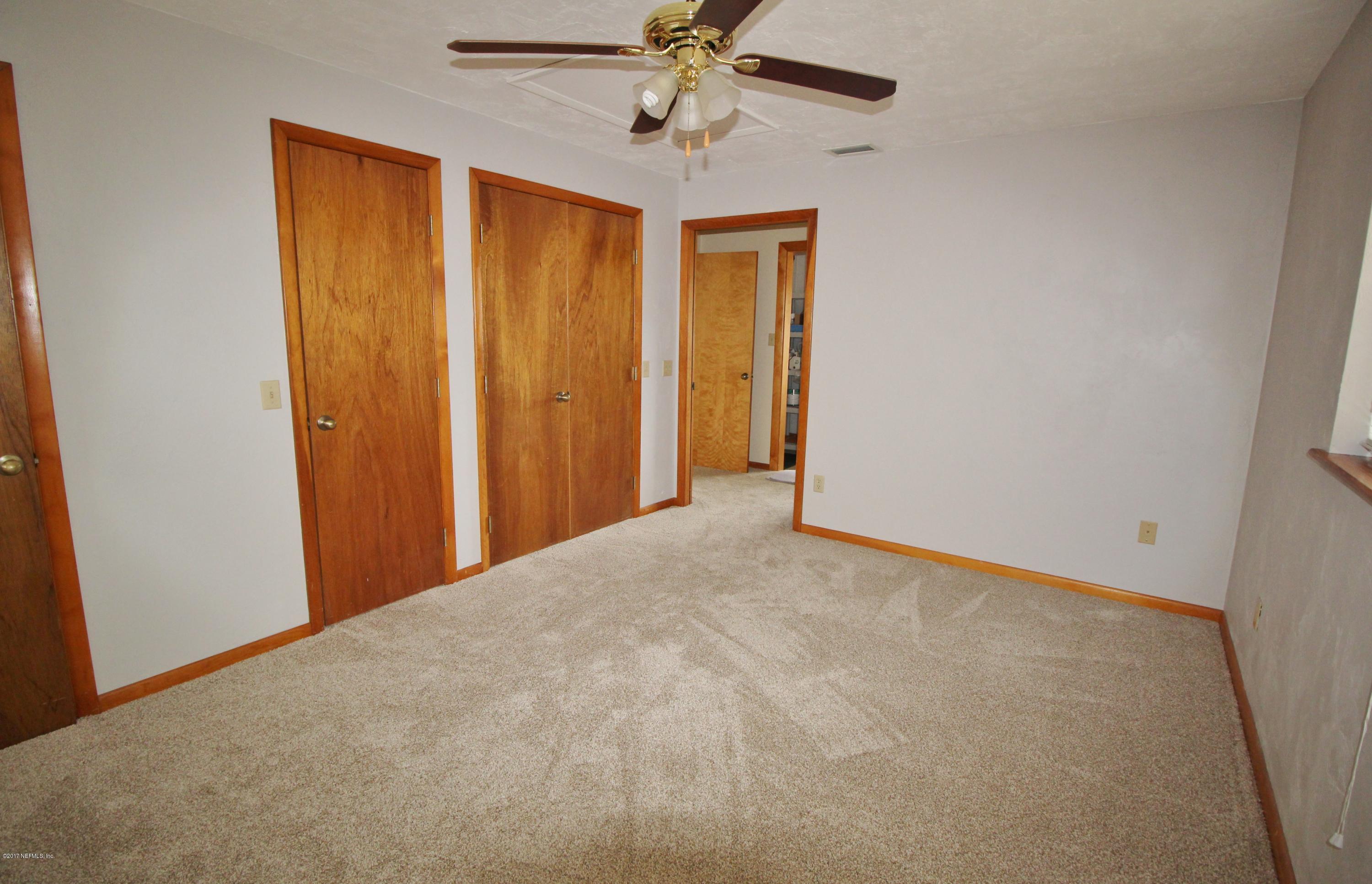 233 Swallow Road St. Augustine, FL 32086 - Photo 18 of 29 a view of a hallway with a chandelier fan