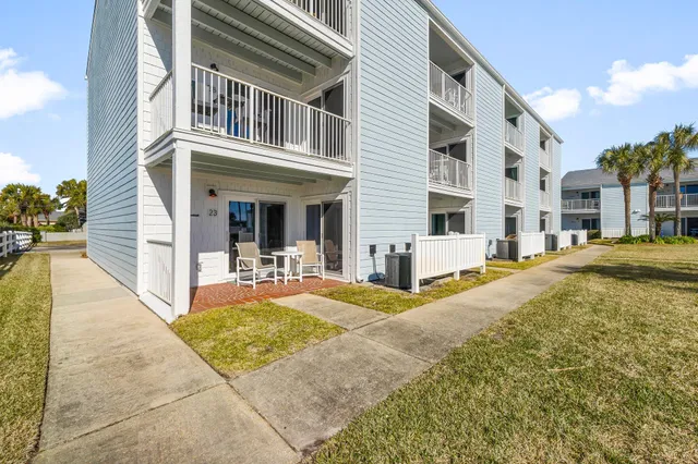 a front view of a house with a garden and plants