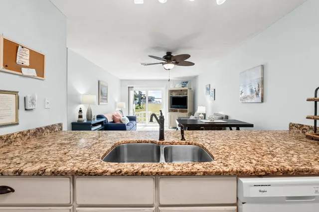 a en suite bathroom with a granite countertop sink and a mirror