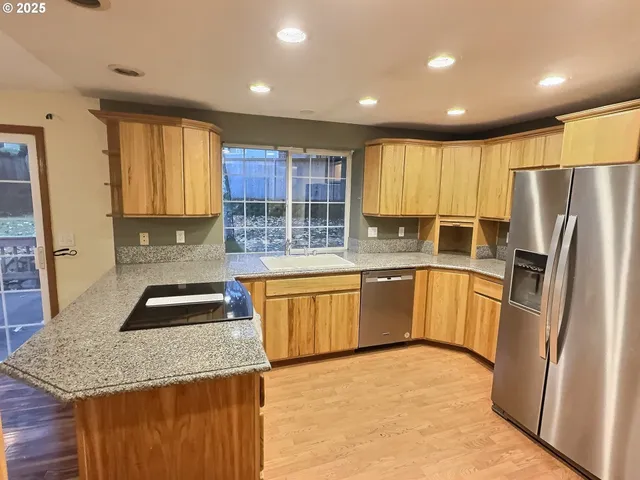 a kitchen with granite countertop counter top space a sink stainless steel appliances and cabinets