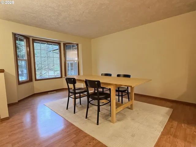 a dining room with furniture and wooden floor