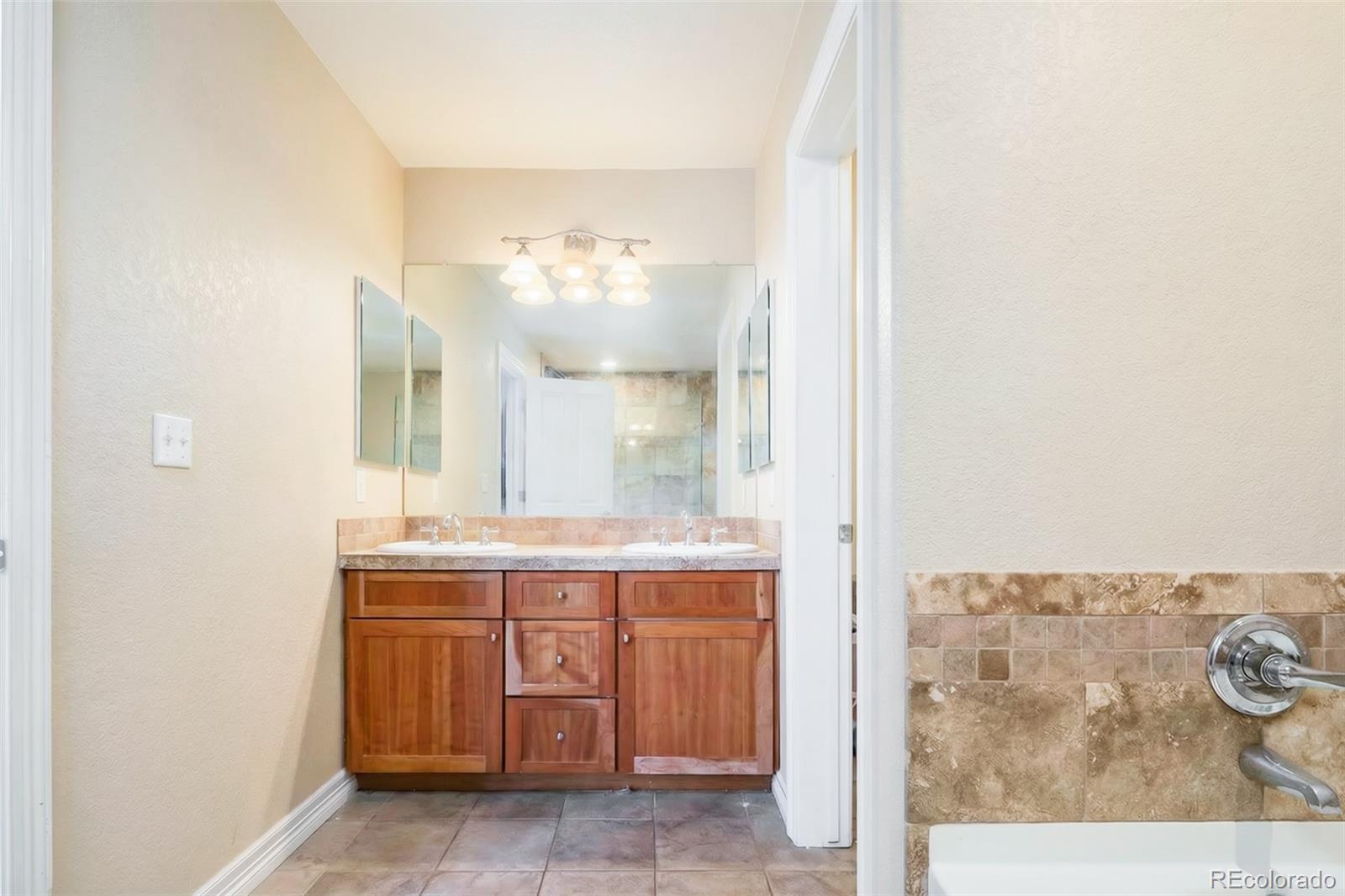 2245 South High Street Denver, CO 80210 - Photo 13 of 33 a bathroom with a sink and a mirror