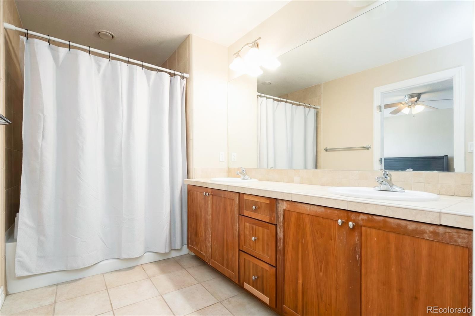 2245 South High Street Denver, CO 80210 - Photo 19 of 33 a bathroom with a double vanity sink and mirror
