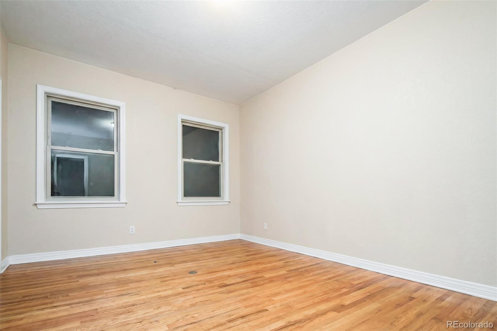 2245 South High Street Denver, CO 80210 - Photo 7 of 33 a view of an empty room with wooden floor and a window