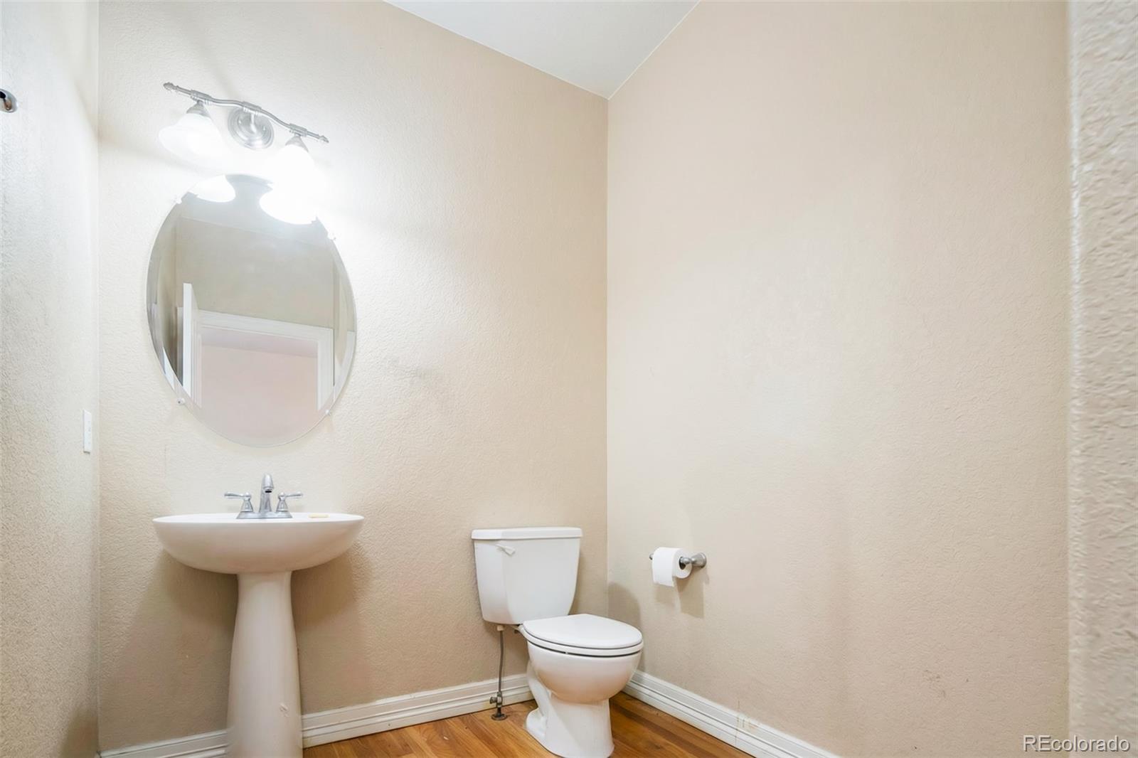2245 South High Street Denver, CO 80210 - Photo 8 of 33 a bathroom with a sink toilet and a mirror