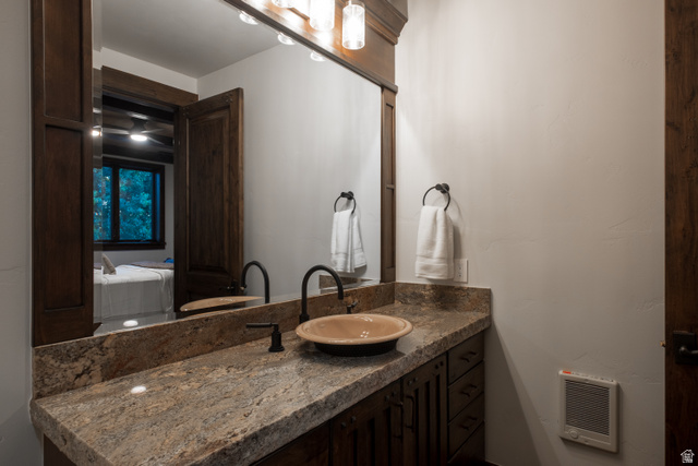 9156 Forest Road, Unit 24 Heber City, UT 84036 - Photo 25 of 42 Bathroom vanity featuring a stone-finish countertop, a bowl sink, and a wall-mounted faucet
