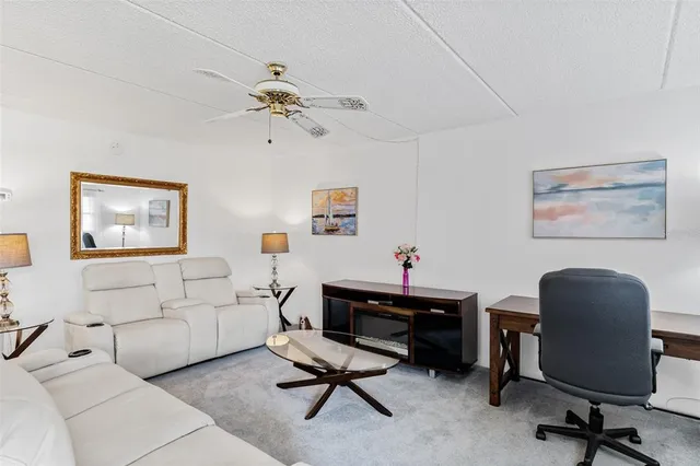 a view of a livingroom with workspace and a couch