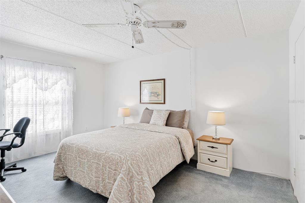 12760 Indian Rocks Road, Unit 546 Largo, FL 33774 - Photo 12 of 45 a bedroom with a bed and large windows