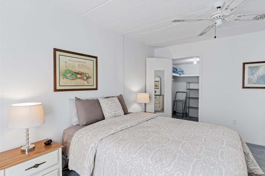 12760 Indian Rocks Road, Unit 546 Largo, FL 33774 - Photo 13 of 45 a bedroom with a bed and a lamp on dresser