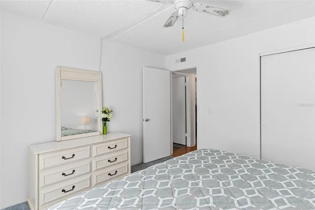 a bedroom with a bed and a dresser in it