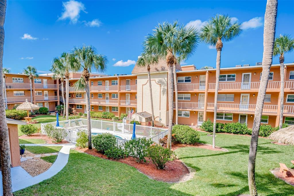12760 Indian Rocks Road, Unit 546 Largo, FL 33774 - Photo 22 of 45 a front view of a building with a garden