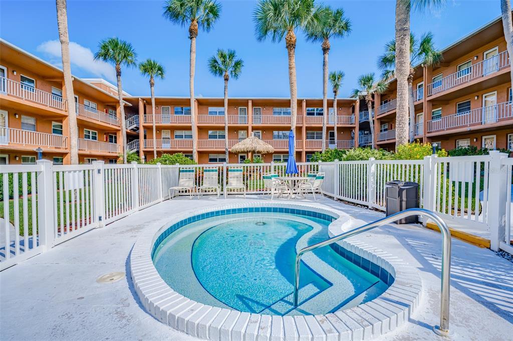 12760 Indian Rocks Road, Unit 546 Largo, FL 33774 - Photo 23 of 45 a swimming pool with outdoor seating and yard