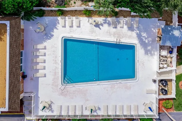 an aerial view of residential house with outdoor space and seating