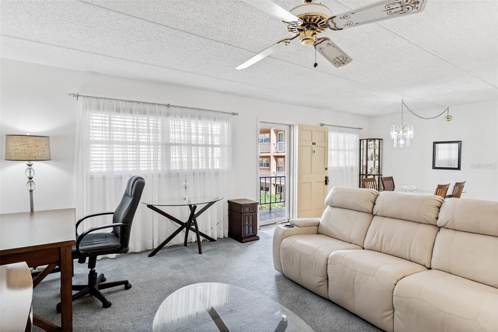 12760 Indian Rocks Road, Unit 546 Largo, FL 33774 - Photo 3 of 45 a living room with furniture a desk and chair with the potted plants
