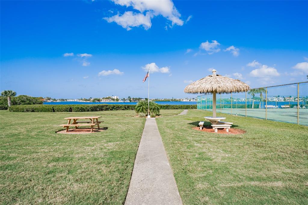 12760 Indian Rocks Road, Unit 546 Largo, FL 33774 - Photo 38 of 45 a view of swimming pool with outdoor seating and lake view