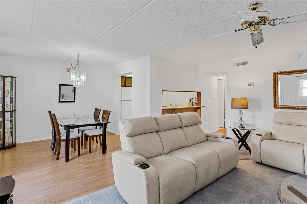 12760 Indian Rocks Road, Unit 546 Largo, FL 33774 - Photo 4 of 45 a living room with furniture and wooden floor