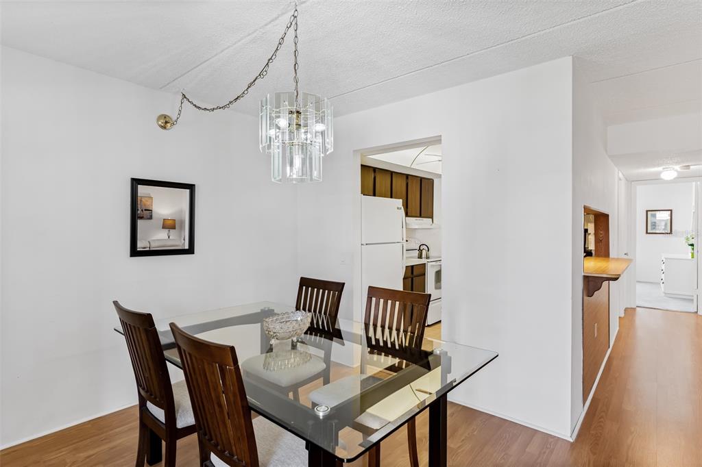 12760 Indian Rocks Road, Unit 546 Largo, FL 33774 - Photo 6 of 45 a view of a dining room with furniture and wooden floor