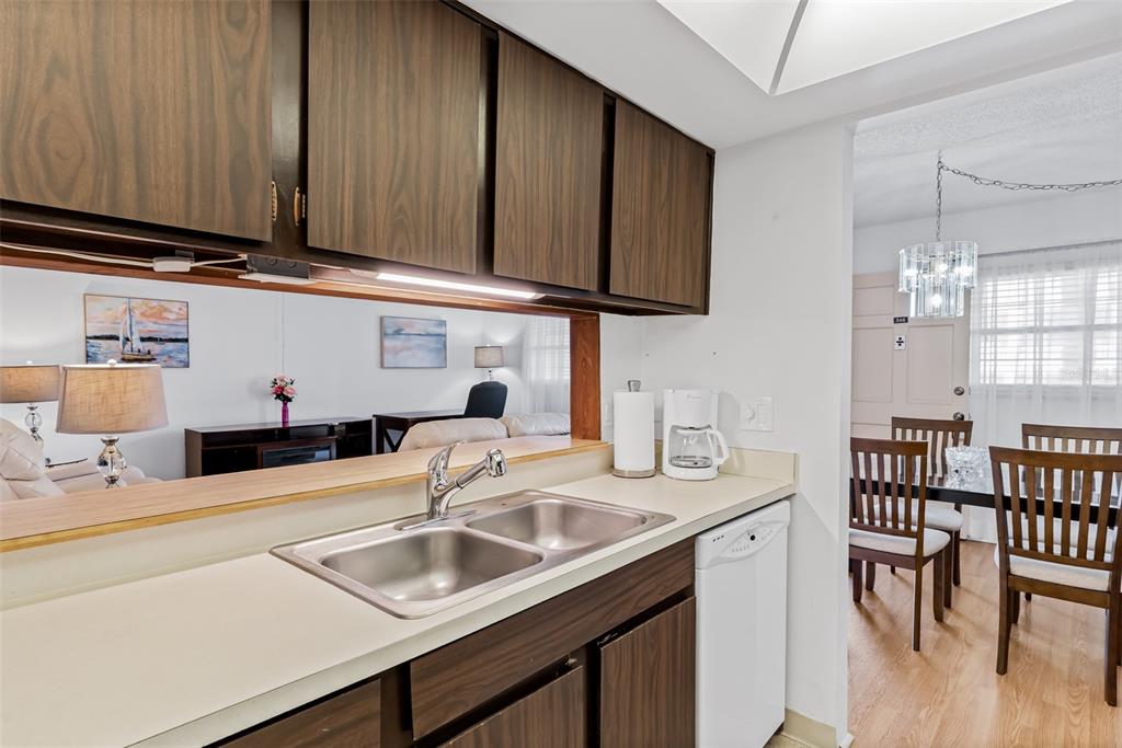 12760 Indian Rocks Road, Unit 546 Largo, FL 33774 - Photo 7 of 45 a kitchen with stainless steel appliances granite countertop a sink and cabinets