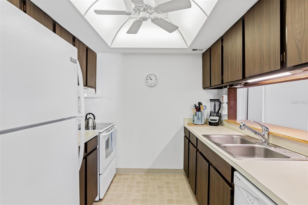 12760 Indian Rocks Road, Unit 546 Largo, FL 33774 - Photo 8 of 45 a kitchen with stainless steel appliances granite countertop a sink stove and refrigerator